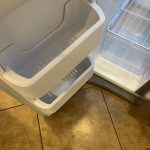 Recently completed fridge cleaning, showcases clean fridge.