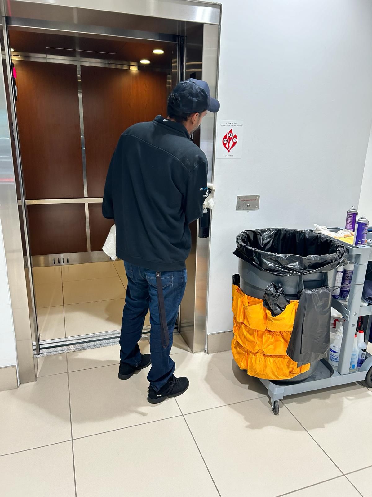 Office cleaning service, elevator being cleaned.