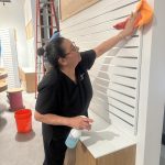 Commercial cleaning service performed by a lady, cleaning building.