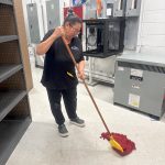 Commercial cleaning service performed by a lady wiping building's floors.